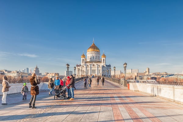 People are on the Patriarshy Bridge near Cathedral of Christ