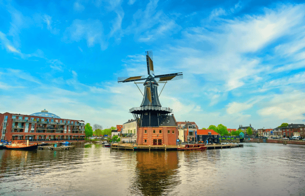 a windmill along canals in haarlem netherlands on a clear day