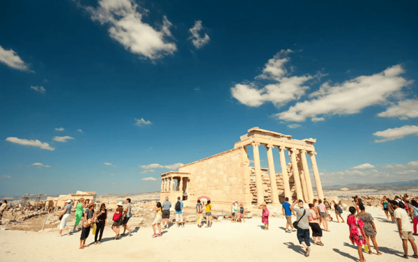 athens greece tourists looking at the ancient greek temple of he erechtheion