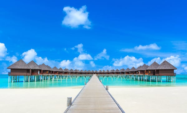 beach with water bungalows at maldives