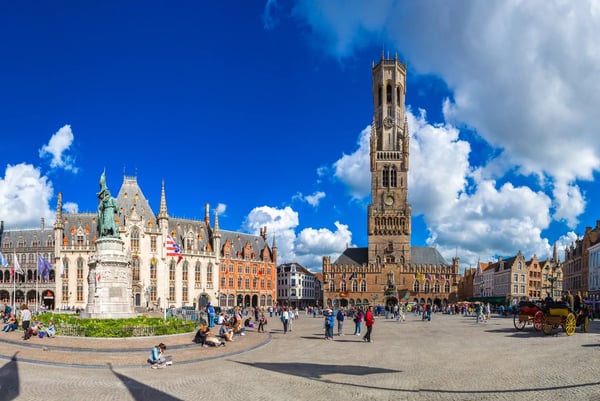belfry tower in the market square in bruges in a beautiful summer day belgium
