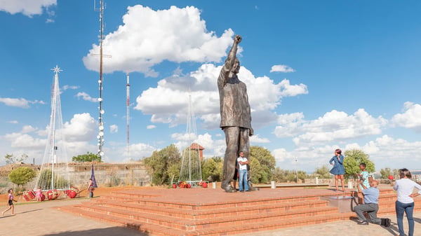 bloemfontein south africa december unidentified visitors at the bronze statue of nelson