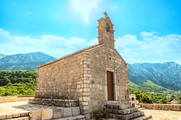 bright sun over saint sava church in the mountains of sveti stefan montenegro 