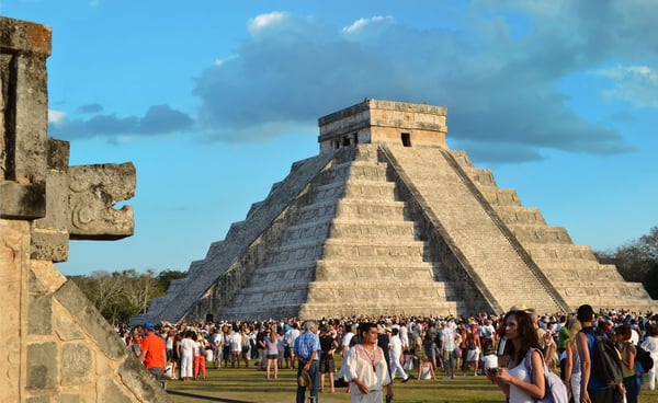 chichen itza mexico march tourists watching the feathered serpent crawling down the temple 