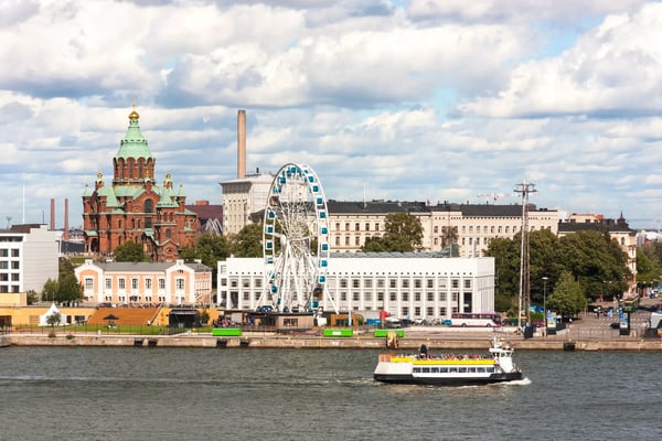 cityscape of helsinki capital of finland with a church and ferris wheel