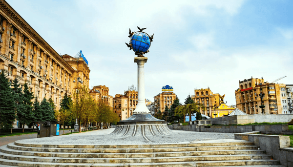 cityscape skyline of kyiv on independence square and blue globe statue 