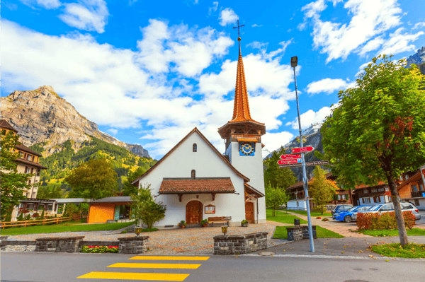 kandersteg switzerland street view with church and bell tower and mountains panorama