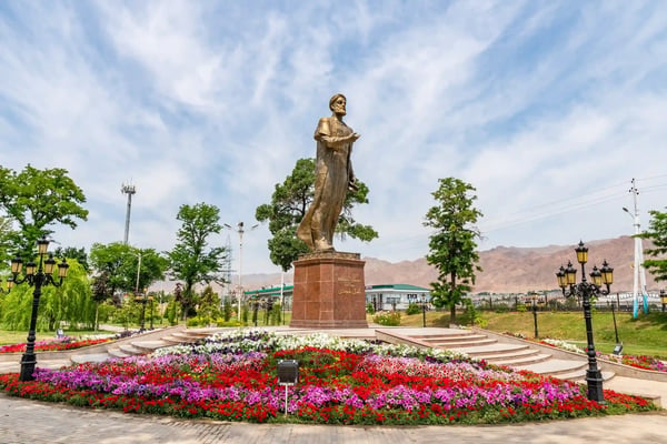 khujand kamoli khujandi park picturesque view of statue with flowers on a sunny blue sky da