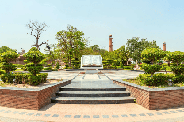lahore iqbal park picturesque view of a book monument with urdu inscription on a sunny blue sky day 
