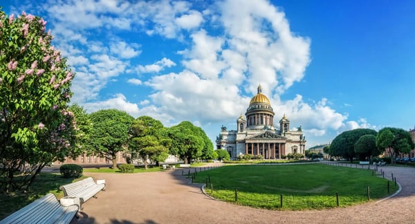 lilac bushes over benches in the park near st isaac s cathedral in st petersburg on a summer sunny
