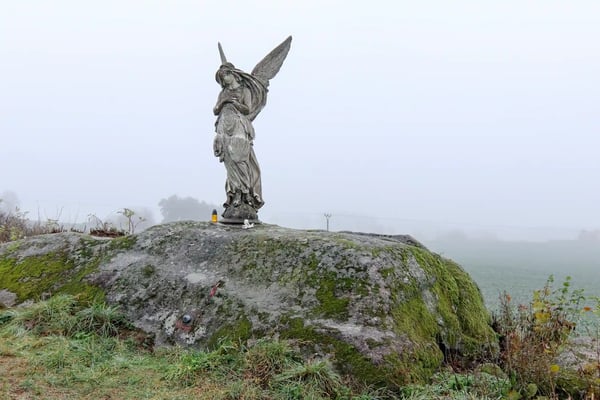 lone statue of an angel in the fields czech republic 