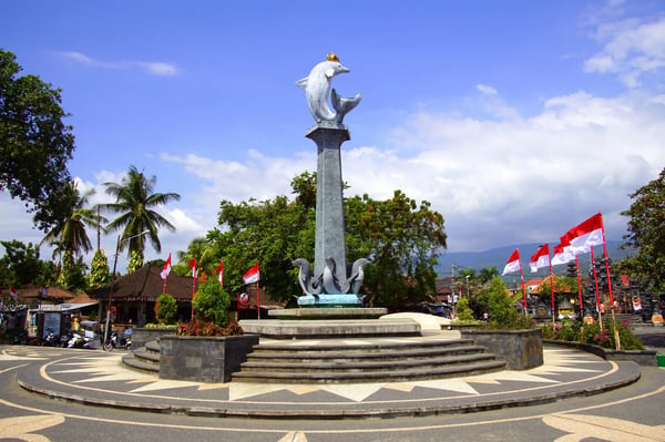 lovina bali indonesia lovina beach dolphin statue against a prtly clouded sky