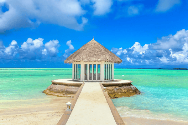 maldives water villas bungalows and wooden bridge at tropical beach in the maldives