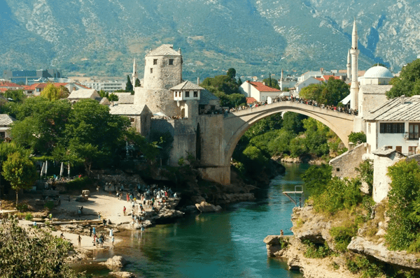 mostar bridge with mountains in background bosnia and herzegovina on summer