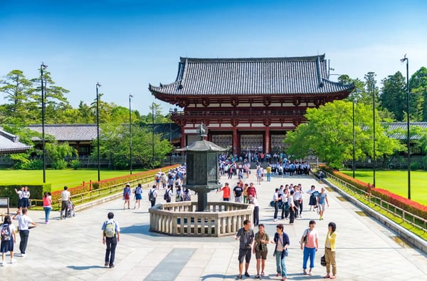nara japan people walk to the great hall of buddhist todai ji temple in nara sheltering 