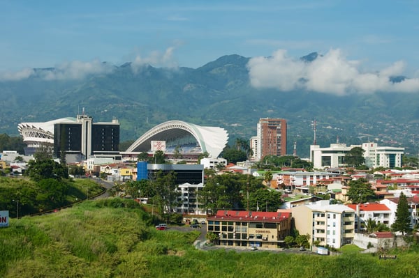 national stadium and residential buildings with mountains at the background in san jose costa rica
