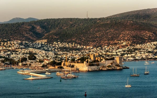 panoramic sunset view of bodrum castle and marina bay on turkish riviera