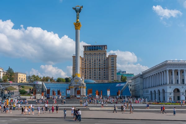 people are strolling in front of the independence memorial at maidan