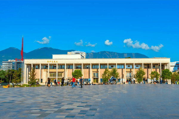 people are strolling in front of the palace of culture on