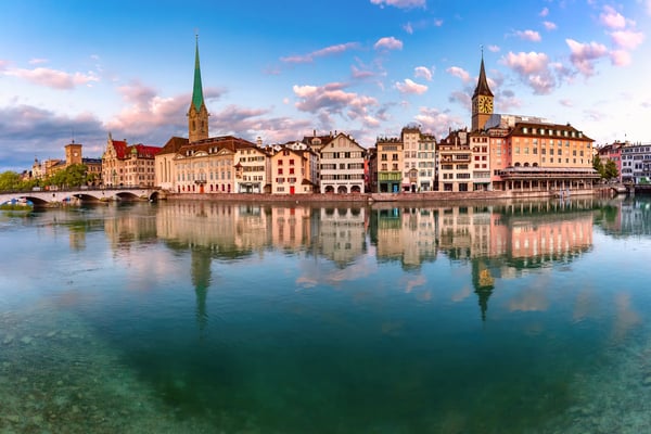st peter church and river limmat at sunrise in old town of zurich