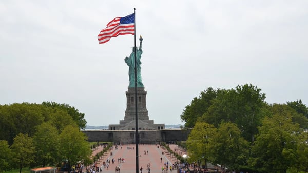 statue of liberty with flag of the united states