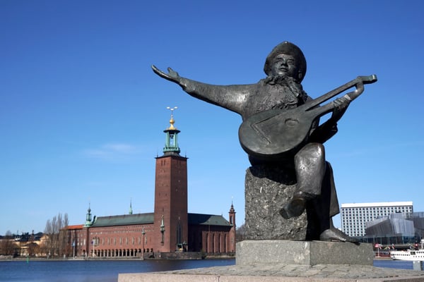 stockholm sweden statue of evert taube with stockholm city hall
