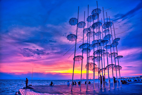 sunset colors over the umbrellas in thessaloniki greece
