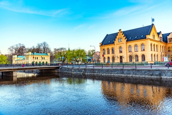 sunset view of notable buildings alongside river fyris in uppsala sweden