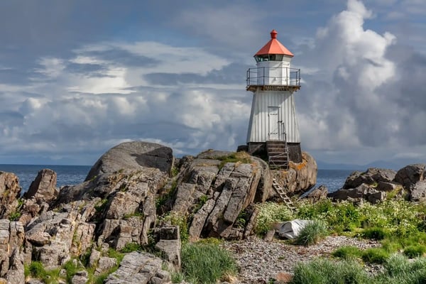 the remains of a whale next to a lighthouse in norway