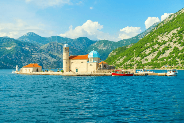the yacht sails near the picturesque gospa od skrpela island in the boka kotorsky bay