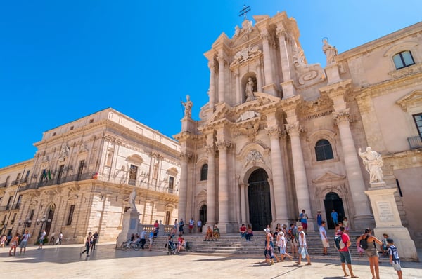 tourists and locals visit main square piazza del duomo in ortigia