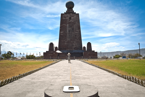 tourists visiting the middle of the world monument in quito ecuador