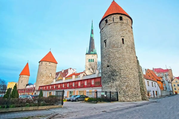 towers of the city wall and st olaf church in the old city of tallinn in estonia in winter