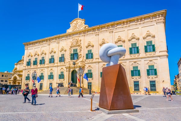 valletta malta people are strolling in front of the auberge de castille seat of the