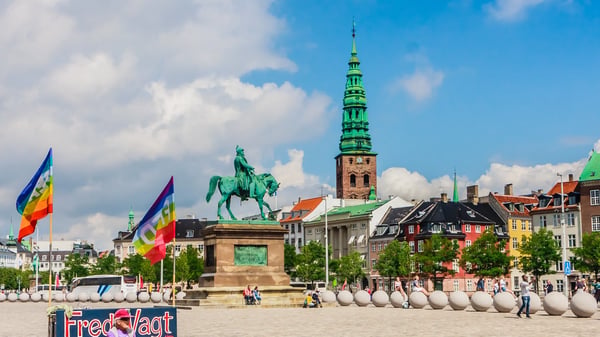 view from christiansborg castle square on nikolaj church and frederik vii equestrian statue