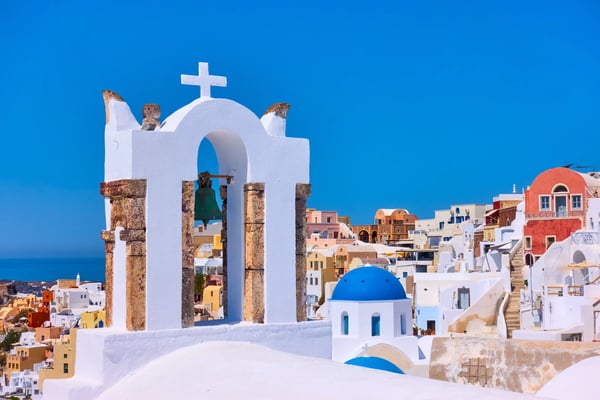 view of oia town in santorini island with old bell tower greece