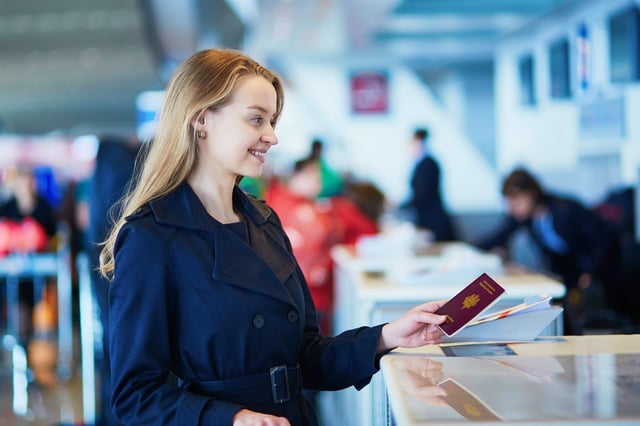A Woman Giving Her Passport To The Official