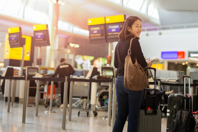 Happy Woman With Smile Hand Holding Passport And Boarding Pass