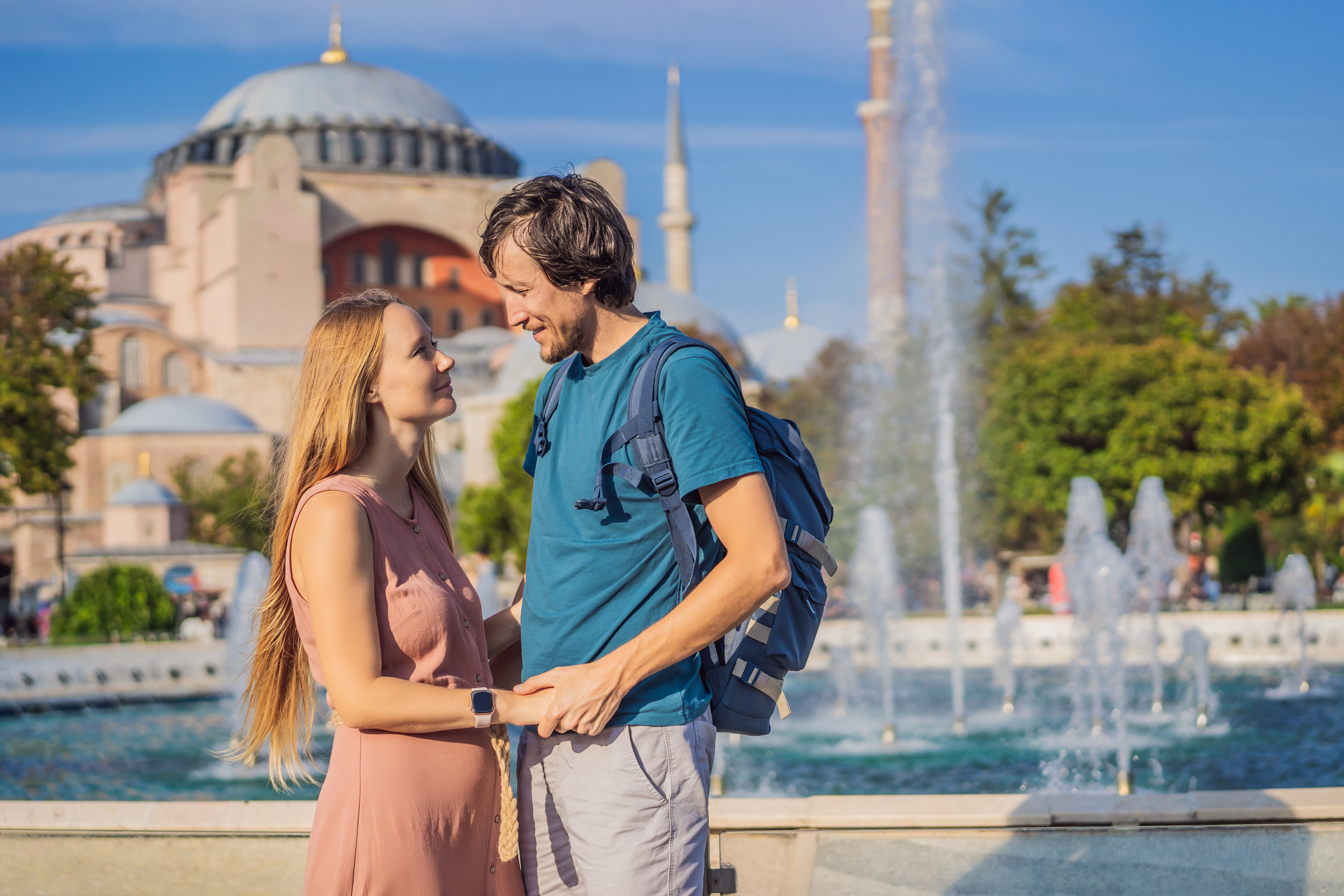 Happy Couple of Tourists in the Honeymoon in Istanbul Enjoy Beautiful View on Hagia Sophia Happy Couple of Tourists in the Honeymoon in Istanbul Enjoy Beautiful View on Hagia Sophia