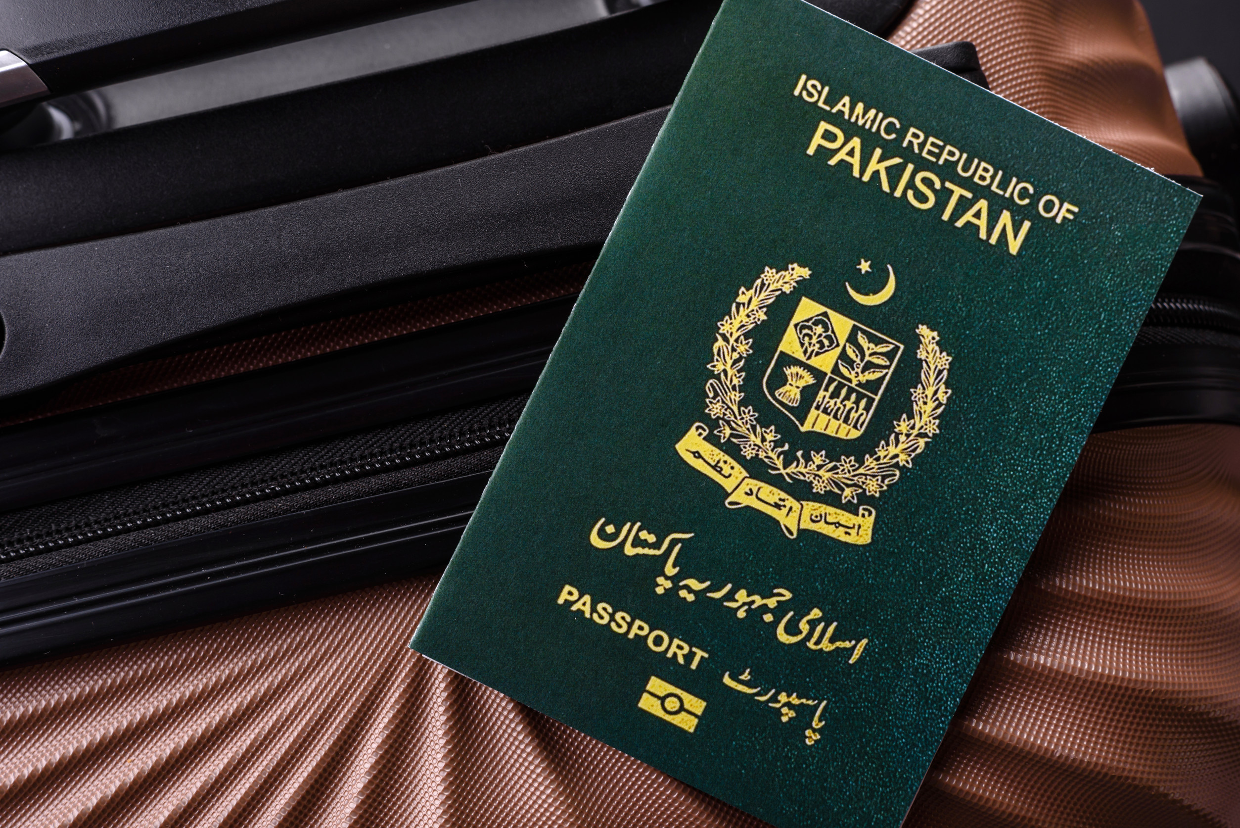 international passport of a citizen of pakistan on a suitcase departure from The Airport international passport of a citizen of pakistan on a suitcase departure from The Airport